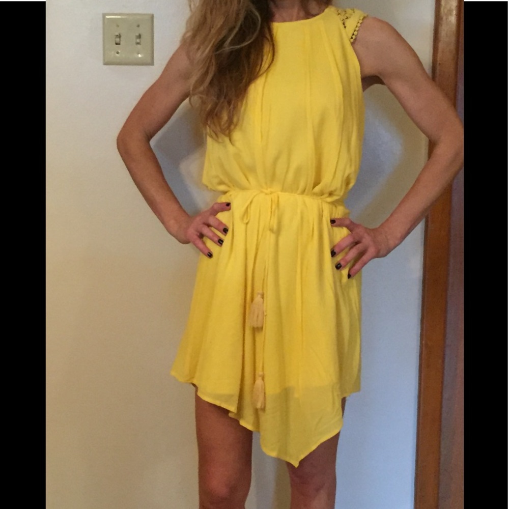 Yellow flowy dress with tie at waist.